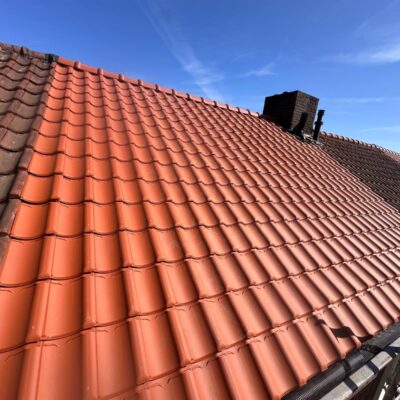 Detail van de strakke nokafwerking na het pannendak vernieuwd dakrenovatie